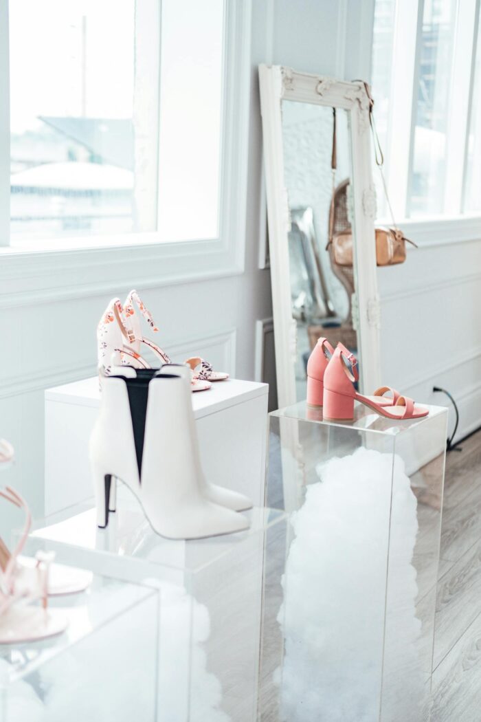 Modern shoe collection elegantly displayed in a chic boutique with natural lighting.