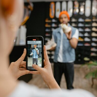 Person filming a shoe shopping experience in a trendy store using a smartphone.